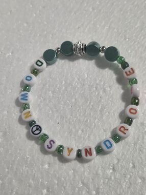 Handcrafted Colorful and Green Stretch Bracelet with the Word 'DOWN SYNDROME'